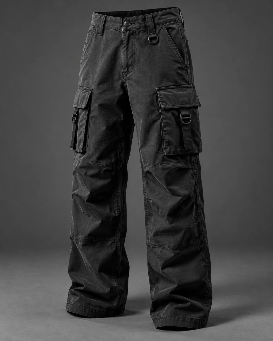 Charcoal straight-leg cargo trousers with side flap pockets on a grey studio background.