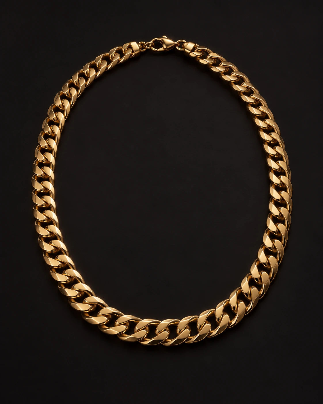 Gold-tone curb-chain necklace arranged in an oval with its clasp visible on a dark background.